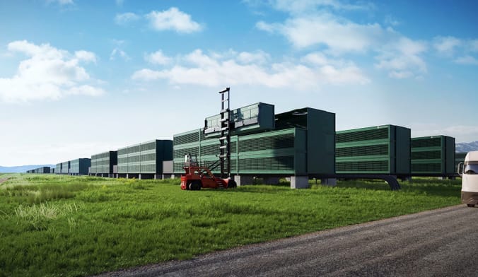 In an open field, a forklift hoists a large rectangular container onto a long row of similar containers