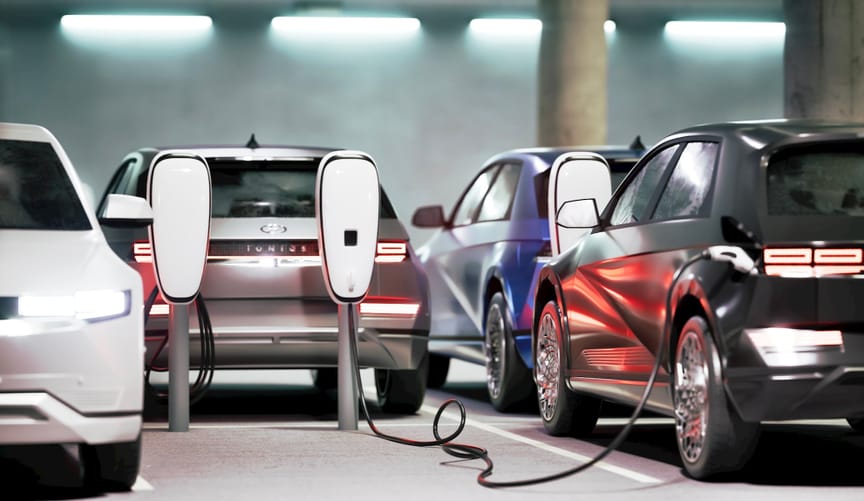 Electric vehicles plugged into chargers in a garage