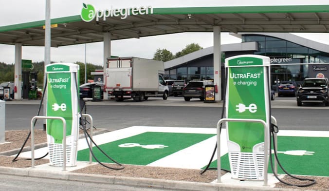 Two bright green Applegreen electric EV chargers at a truck stop