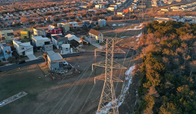 Aerial shot of a neighborhood and electrical lines