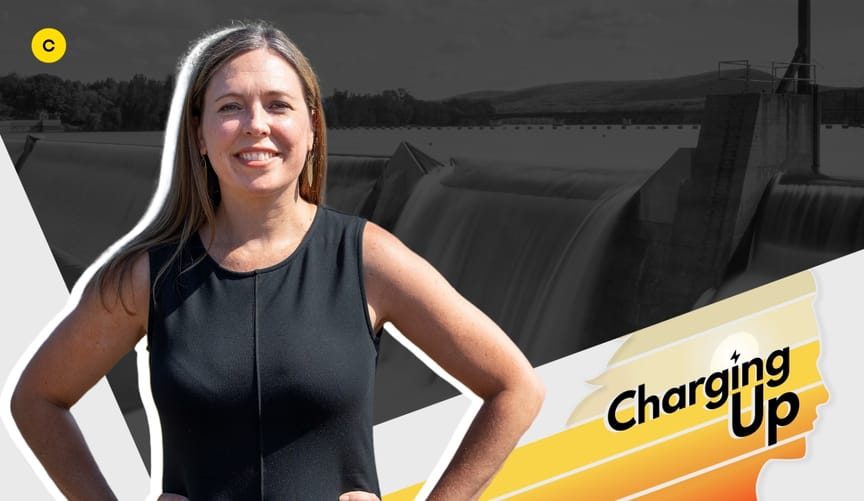 A woman with arms akimbo and long straight brown hair wearing a sleeveless black top next to a graphic that reads Charging Up