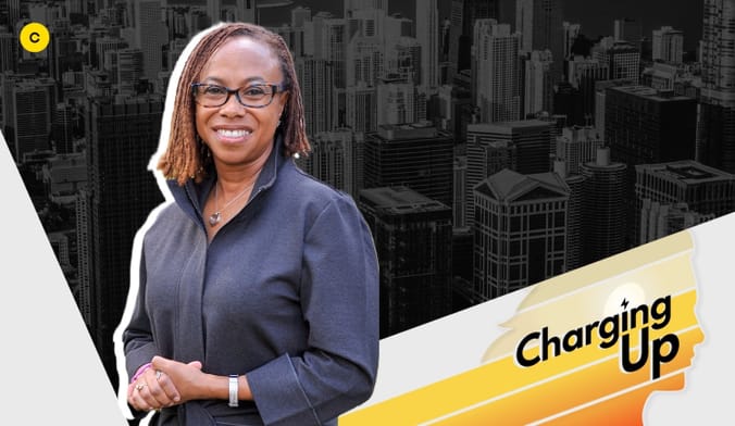 An African American woman wearing glasses and a dark shirt smiling, next to a stylized graphic with the words charging up