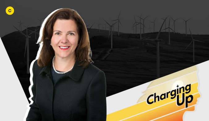 a smiling woman with brown hair wearing a black jacket next to a graphic that says Charging Up