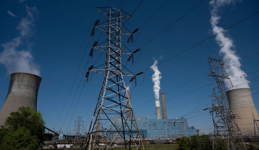 Clouds of steam and smoke rise from stacks at a coal-fired power plant