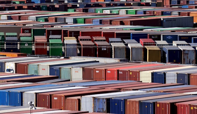 Rows of multicolored metal rectangular container boxes lined up at a port