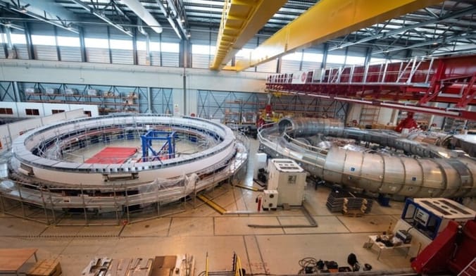 Two large metal coils inside a huge industrial warehouse