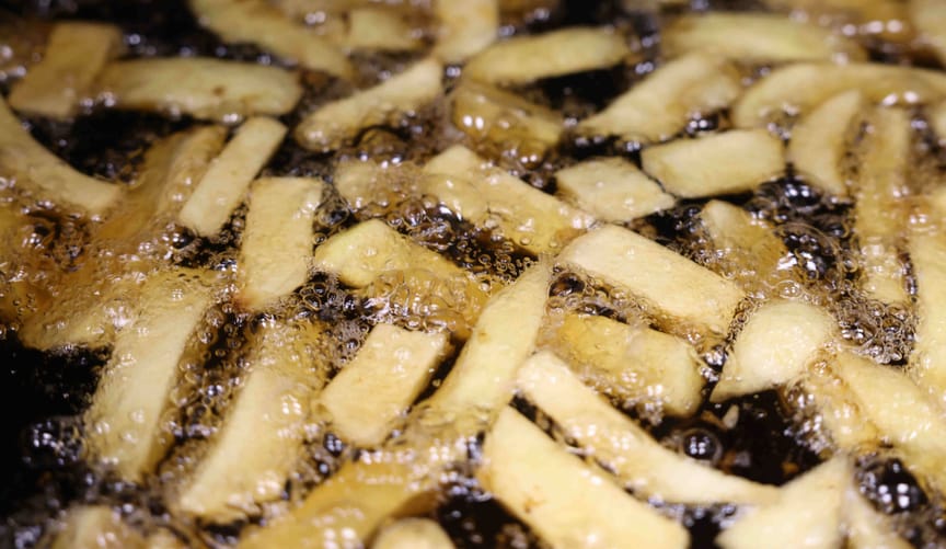 French fries being cooked in a vat of grease