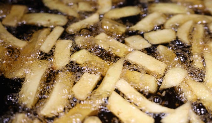 French fries being cooked in a vat of grease