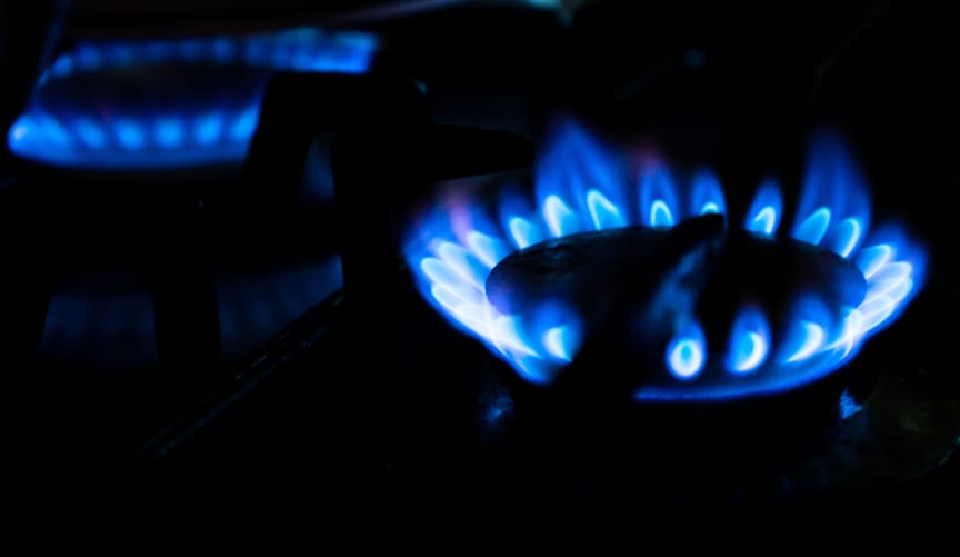 close-up image of two blue flames from gas stove burners
