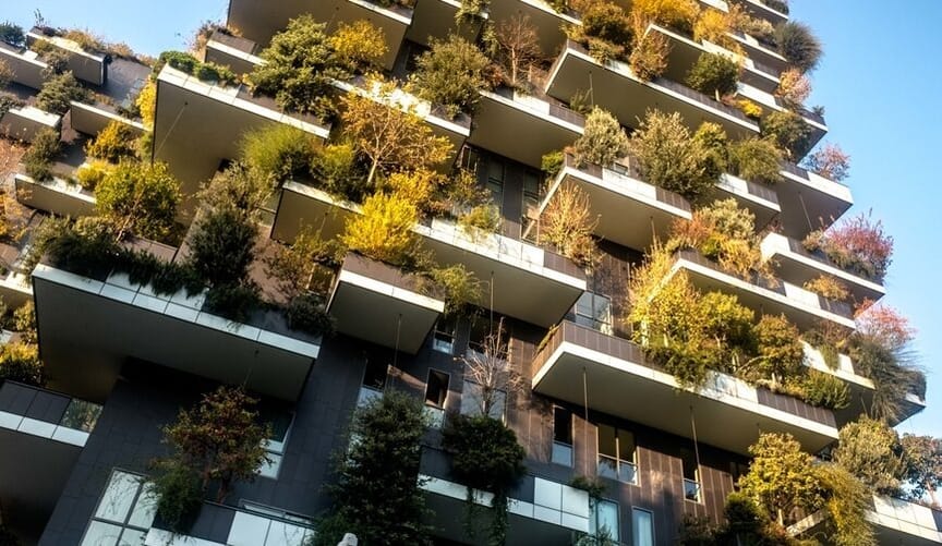 A tall building with the façade covered in various green plants