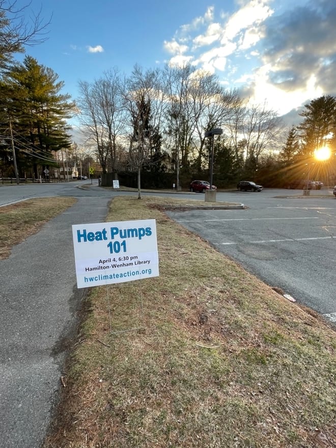 A yard sign stick in a lawn that says Heat Pumps 101