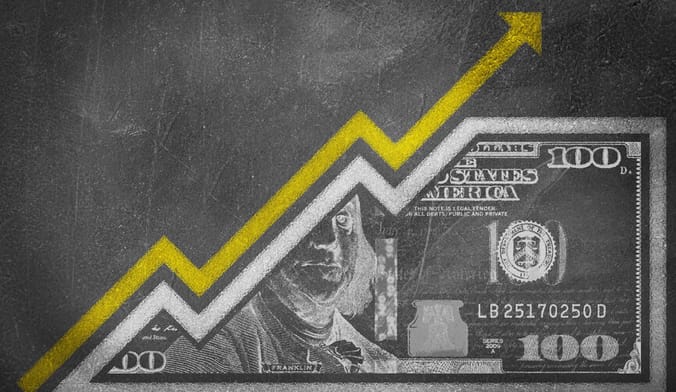 A chalkboard drawing of a 100-dollar bill with a yellow upward-pointing arrow representing inflation