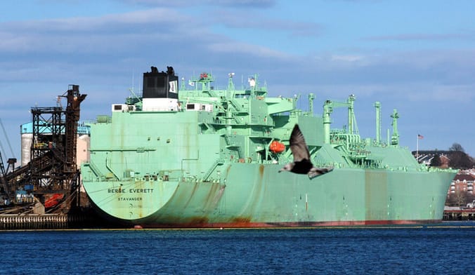A large green LNG tanker at port