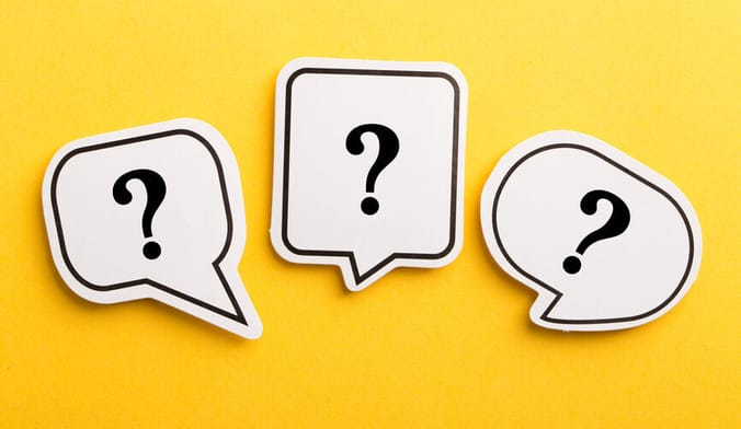 Three speech bubbles with question marks on a bright yellow background
