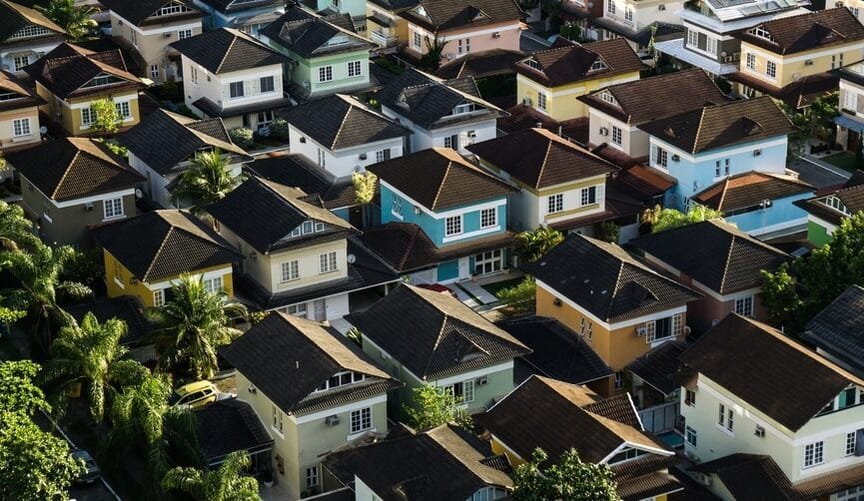 An aerial view of rows of houses in various pastel shades