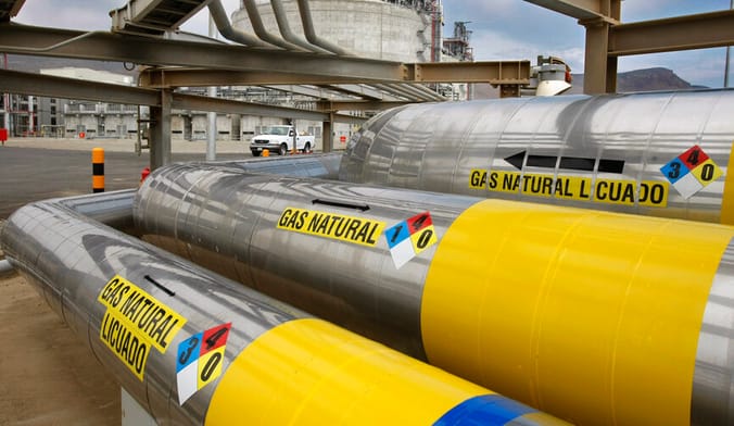 Several large silver metal pipes with labels that read GAS NATURAL LICUADO