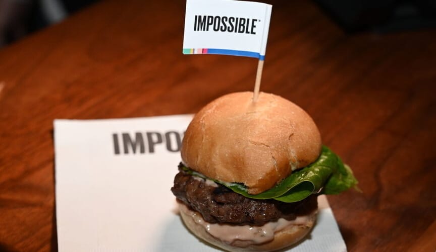 A small slider burger with a toothpick flag that says impossible