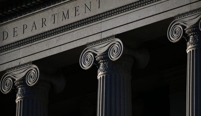 A moody, atmospheric shot of the facade of the Treasury Department building in Washington, DC.