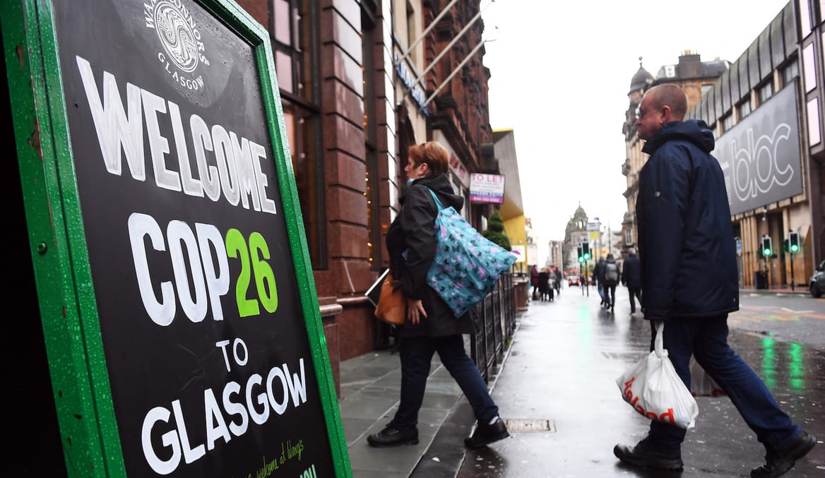 sidewalk sign: "Welcome COP26 to Glasgow"