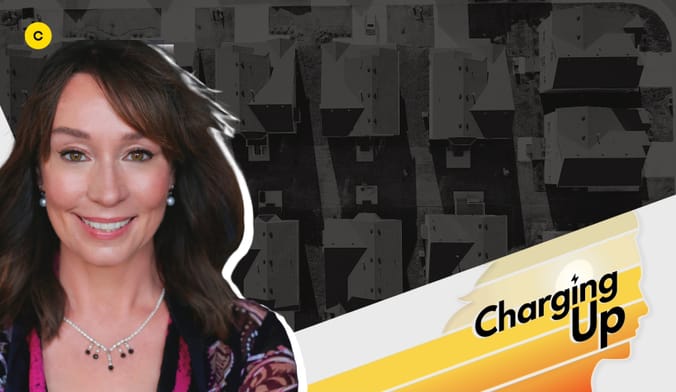 A smiling woman with a light skin tone and shoulder-length brown hair next to a stylized graphic that reads "Charging Up"