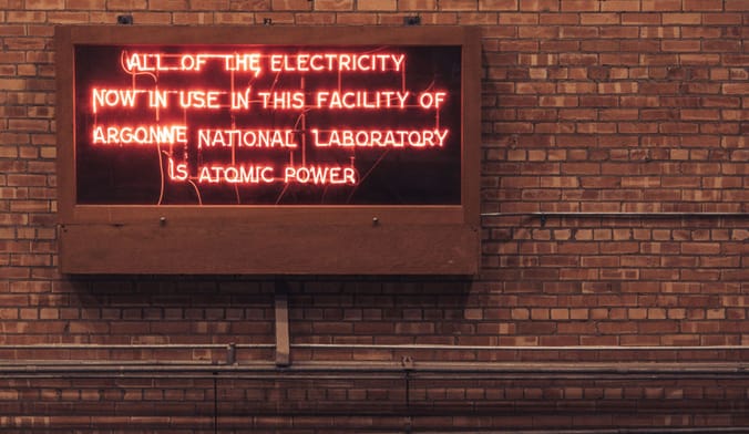 A red neon sign that says all of the electricity now in use in this facility of Argonne National Laboratory is atomic power
