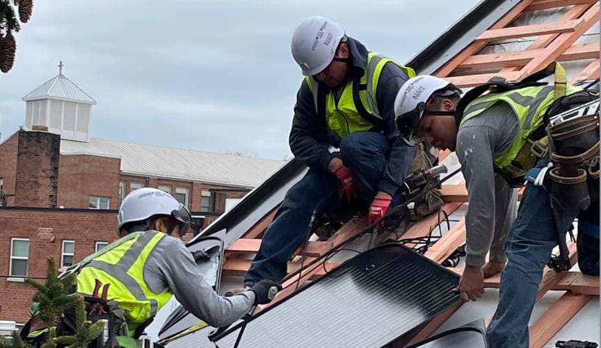 Solar installers on a rooftop in Washington DC