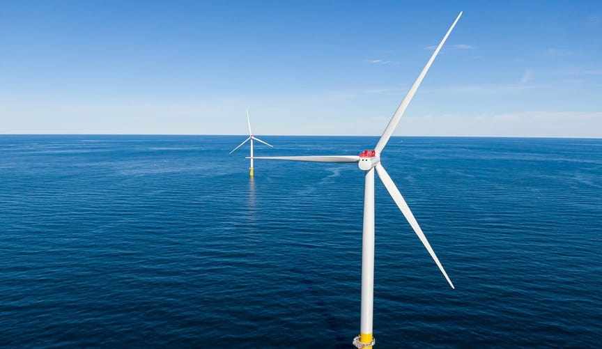 Two large wind turbines in the ocean