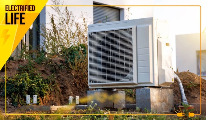Heat pump on concrete blocks outside a home in the sun.