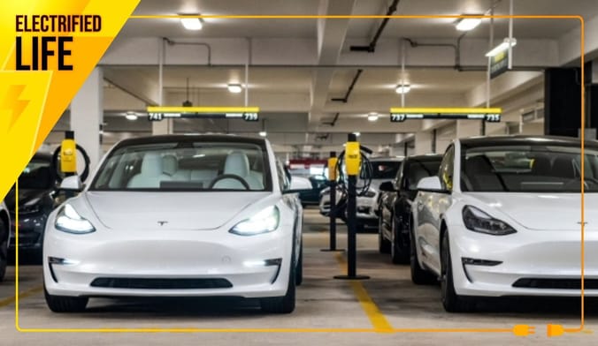 White Teslas available for rent in a Hertz parking structure.