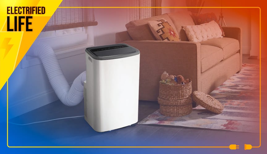 Living room with white and black micro heat pump, a.k.a. portable AC with heat, with a hose fit into into the window frame.