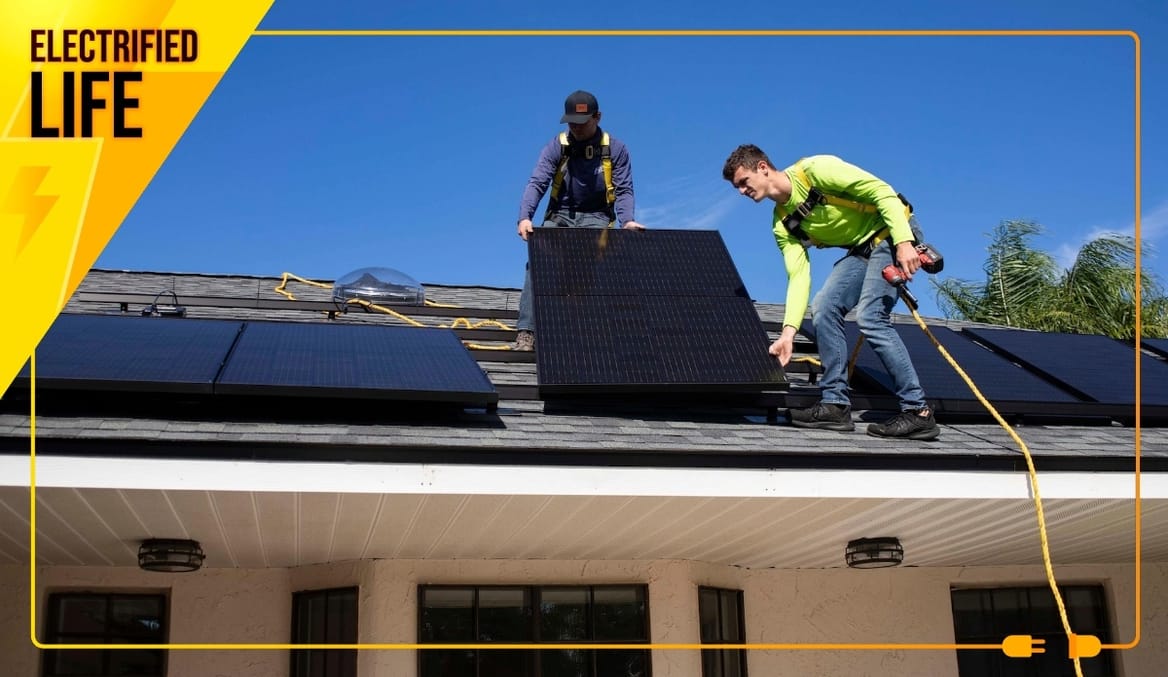 Two people install silicon solar panels on a residential roof in Florida. A yellow graphic frame says Electrified Life