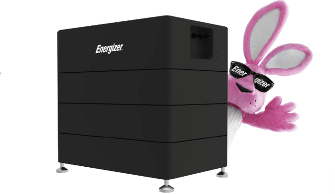 A cartoon pink bunny wearing sunglasses that say ENERGIZER stands behind a large black device that says ENERGIZER