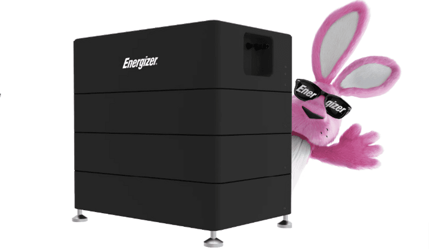 A cartoon pink bunny wearing sunglasses that say ENERGIZER stands behind a large black device that says ENERGIZER