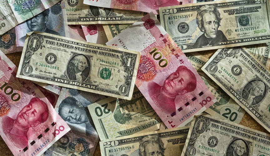 A pile of american and chinese paper currency
