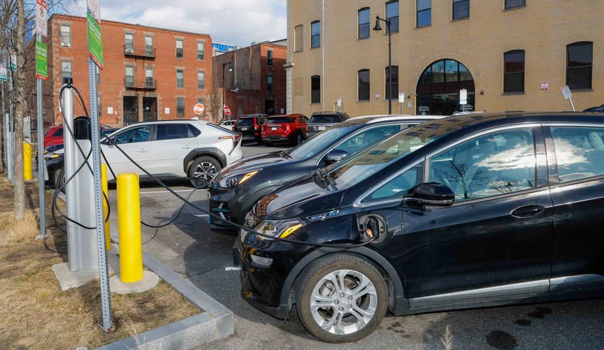 Electric vehicles plugged in to a curbside EV charging station