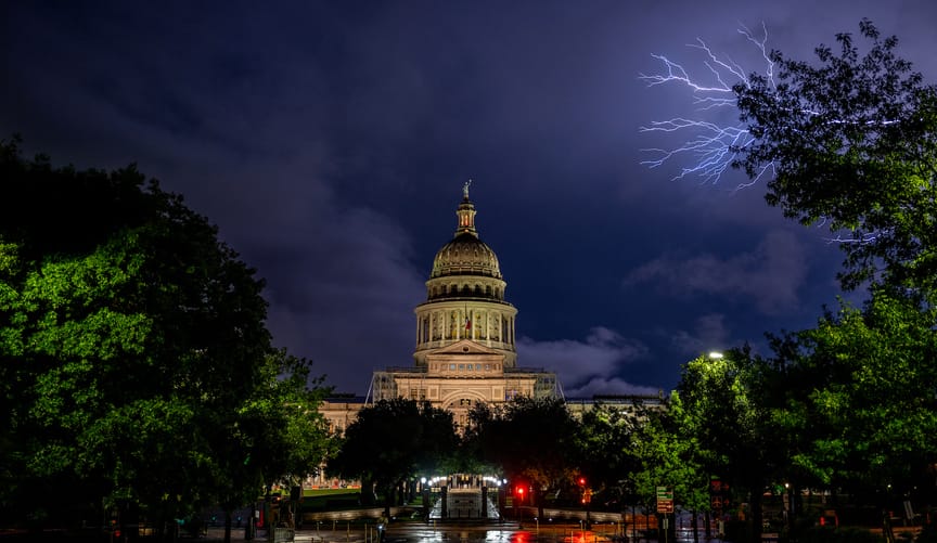 Lightning flashes behind the Texas State Capitol.
