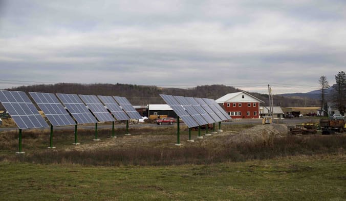 Two rows of photo voltaic panels sits across the road from the Wysocki Dairy Farm