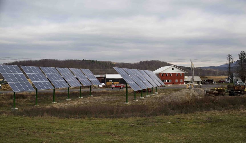 Two rows of photo voltaic panels sits across the road from the Wysocki Dairy Farm