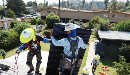 Grid Alternatives employees install rooftop solar in Pomona California