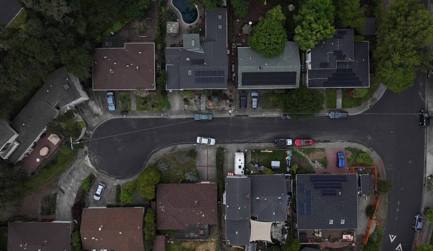 In an aerial view, solar panels are seen on the roofs of homes in a neighborhood on April 25, 2024 in San Rafael, California.