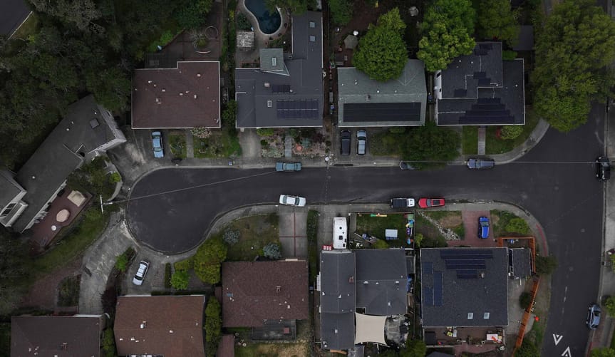 In an aerial view, solar panels are seen on the roofs of homes in a neighborhood on April 25, 2024 in San Rafael, California.