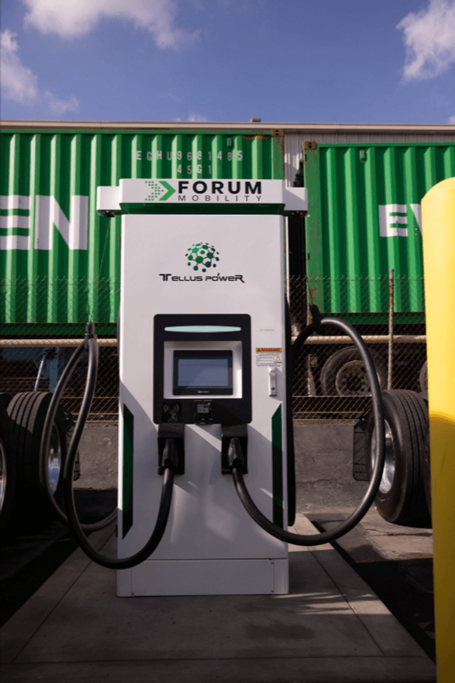 A large white EV charging station with two plugs
