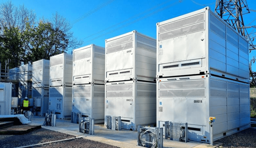A row of stacked large white metal rectangular boxes