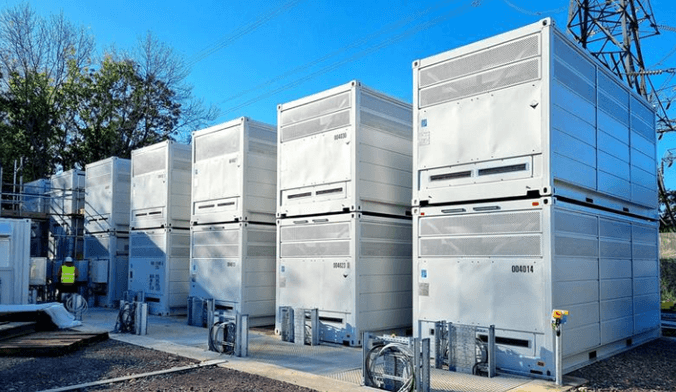 A row of stacked large white metal rectangular boxes