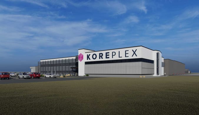 An artist rendering of a large white industrial facility with the word KOREPLEX