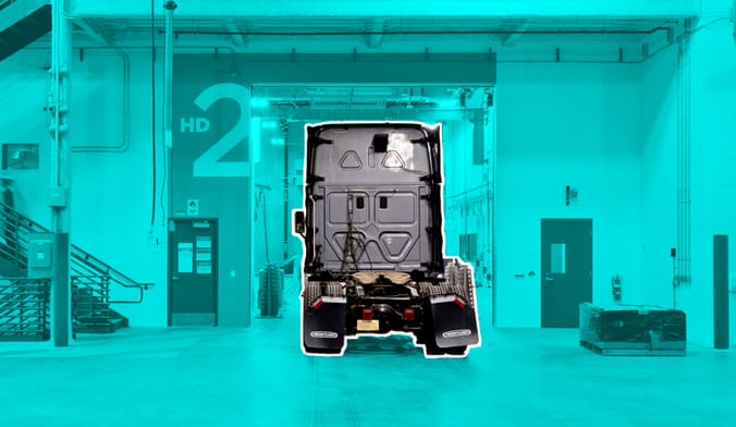 A diesel truck inside a large warehouse.