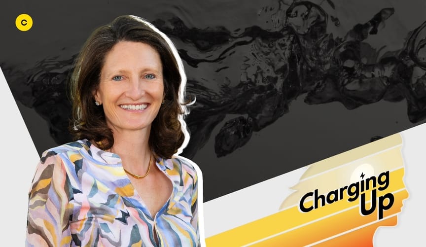 A woman with light skin and shoulder length wavy brown hair wearing a multicolored blouse. A graphic says Charging Up