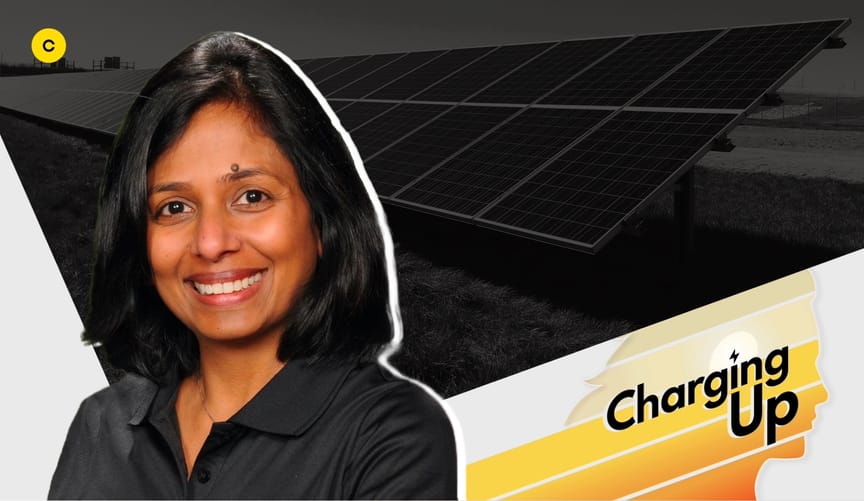 A smiling woman with medium-length dark hair and medium skin tone wearing a black shirt. An overlay graphic says Charging Up
