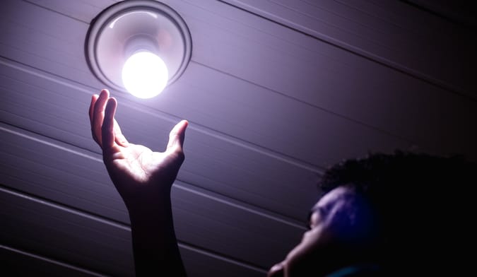 man putting in light bulb
