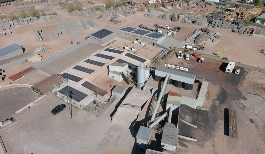An aerial view of an industrial facility on a dusty desert lot